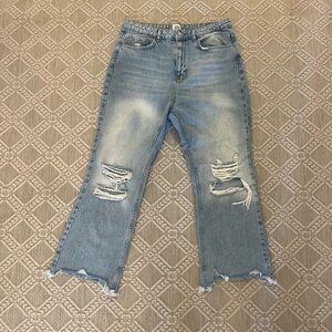 BDG distressed light-wash jeans with rips at knees and frayed hem